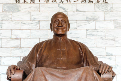 Portrait of buddha statue against wall