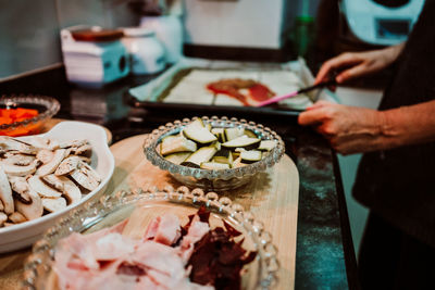 Midsection of man preparing fish on table