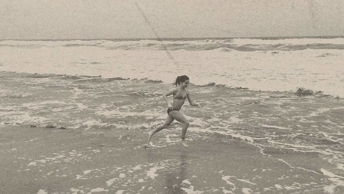 FULL LENGTH OF SHIRTLESS WOMAN ON BEACH
