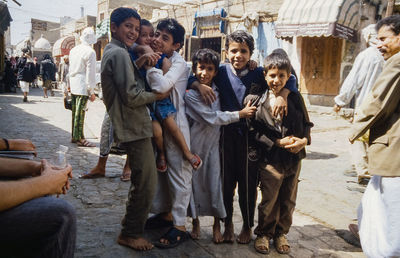 People standing on street against buildings in city