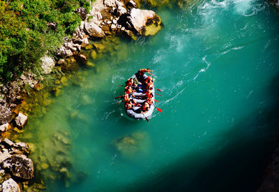 High angle view of people on rock by river