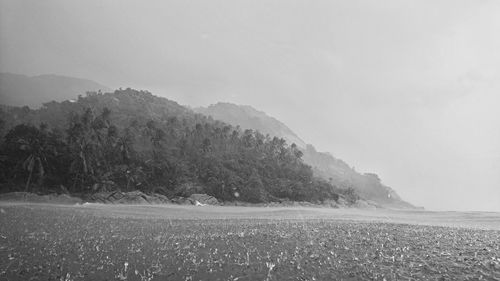 Scenic view of land and mountains against sky
