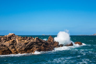 Scenic view of sea against clear blue sky