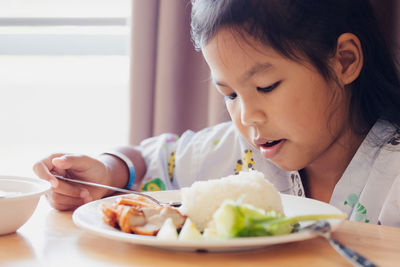 Midsection of woman eating food