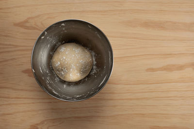 High angle view of bread in bowl on wooden table