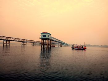 Scenic view of pier on sea against sky during sunset