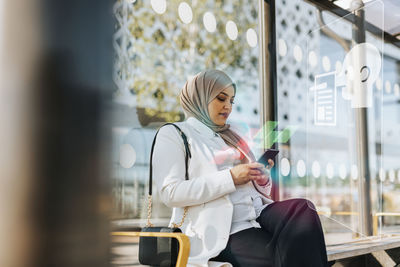 Woman reading fake news on cell phone