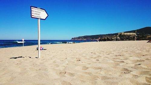 View of beach against clear blue sky