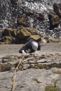 Rear view of man on rock