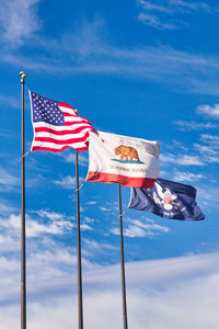 Low angle view of flags flag against sky