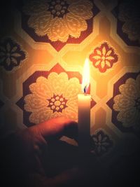 View of lit candle in darkroom