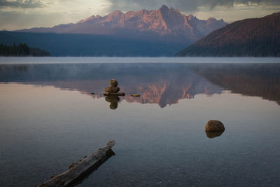 Scenic view of lake by mountains against sky