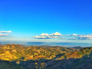 Scenic view of landscape against blue sky