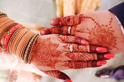 Low section of woman with tattoo on hands