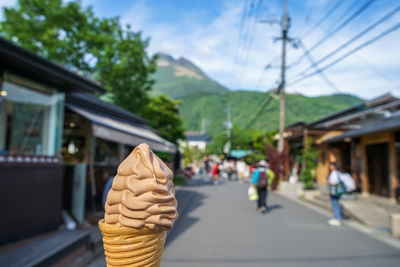 Close-up of ice cream cone against sky