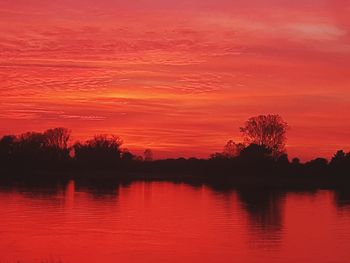 Scenic view of lake against romantic sky at sunset