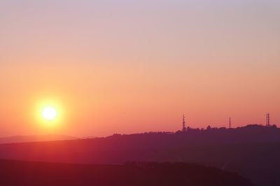 Scenic view of silhouette mountain against romantic sky at sunset