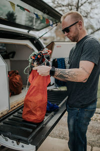 Man putting climbing harness in gear bag