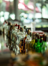 Glass of bottles in bar