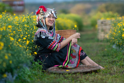 Full length of woman sitting on field