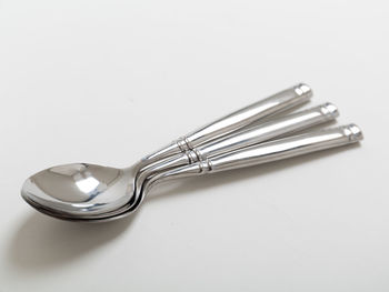 High angle view of glasses on table against white background