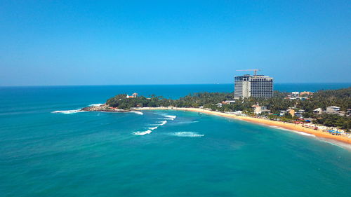 Scenic view of sea against clear blue sky