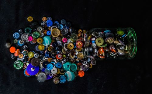 High angle view of multi colored buttons on table