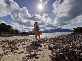 Woman on beach against sky