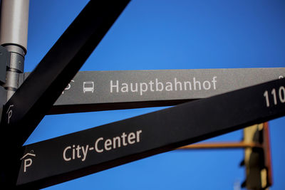 Close-up of information sign against clear blue sky