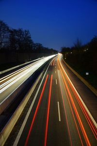 High angle view of light trails on road at night