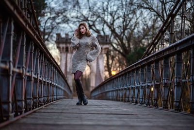 Full length of woman on footbridge