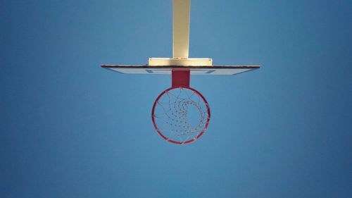 Close-up of basketball hoop against clear blue sky