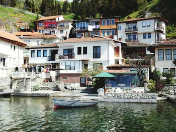 Boats in canal with buildings in background
