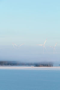 Wind turbine against blue sky