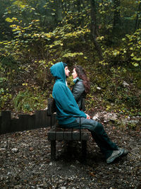 Couple sitting on bench in park