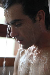 Close-up portrait of young man looking away