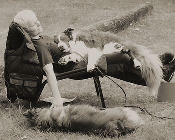 Children playing with dog on field