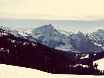 Scenic view of snowcapped mountains against sky