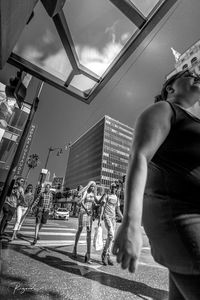 Low angle view of people standing on street