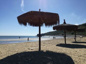 Lifeguard hut on beach against sky