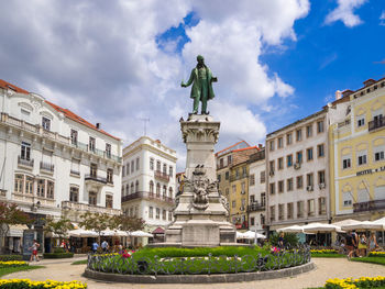 Statue of buildings against cloudy sky