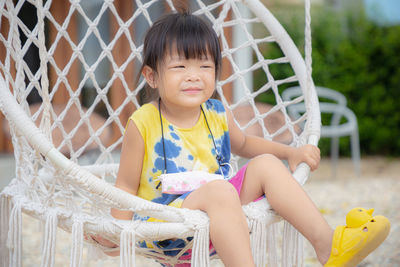 Cute girl sitting outdoors