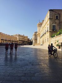 Man riding bicycle on city street