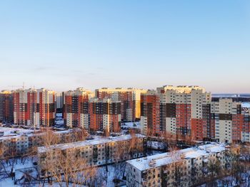 High angle view of buildings against sky during winter morning 