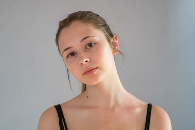 Portrait of a beautiful young woman over white background