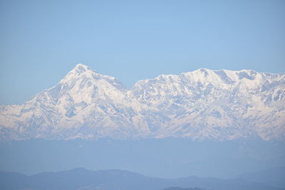 Scenic view of snowcapped mountains against clear sky