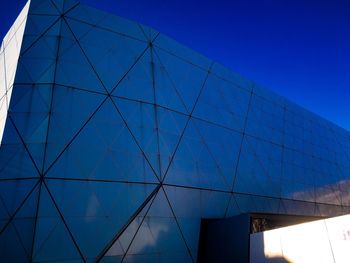 Low angle view of modern building against clear blue sky