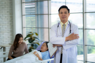 Portrait of young man standing in office