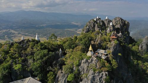 Panoramic view of trees and mountains against sky