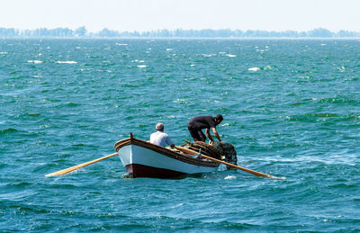 Fishermen in boat on sea